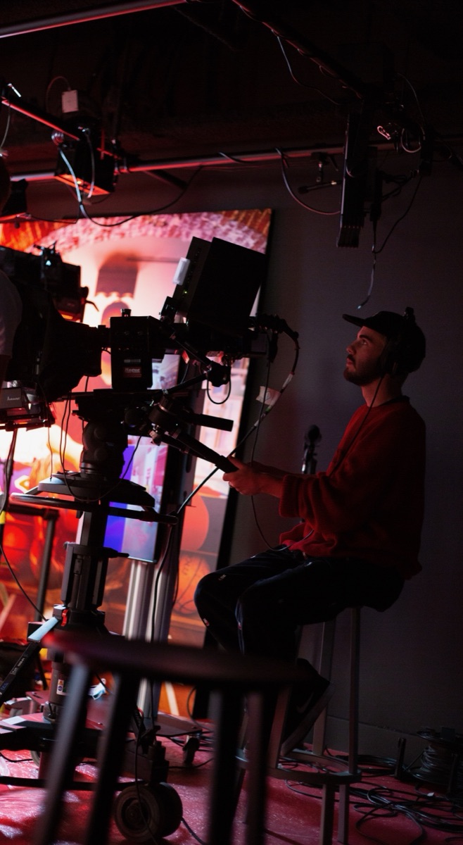 Milo M operating a camera rig on set